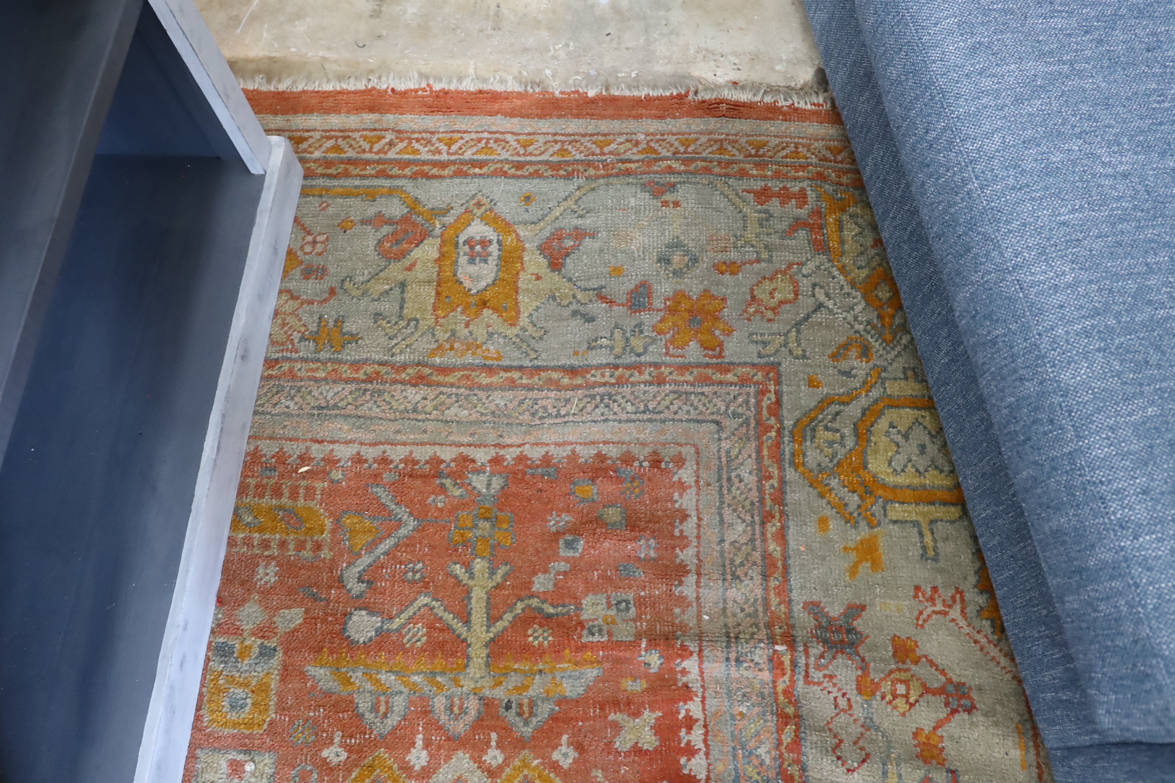 An Afghan red ground carpet, 395 x 310cm